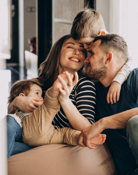 Young family with their sons at home having fun